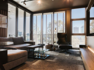 Living room with king Living sofa and armchair. Glass display coffee table.