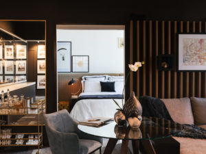 Living room with feature battens, full height mirror, brass bar cart, coco republic dining chair and King living sofa