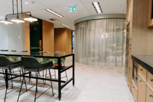 Break out area with Fat shack vintage Printmaker Rod pendant light, Vorsen Coco kitchen stool and timber kitchen and wall panels. Curtain divider between breakout area and collaborative space