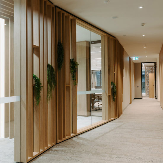 Office lift lobby with feature timber battening and shelving for greenery.
