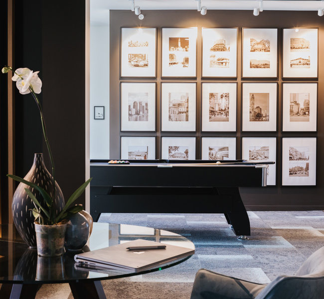 Living room vase décor on study table. Pool room with full artwork wall.